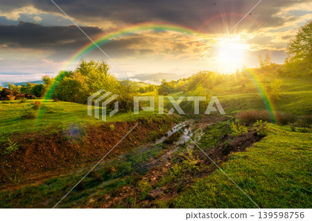 foggy sunset over carpathian mountain landscape. outdoor adventure with stunning view in evening light. countryside landscape with rolling hills, fog and cloudy sky. weather with rainbow foggy sunset over carpathian mountain landscape. outdoor adventure with stunning view in evening light. countryside landscape with rolling hills, fog and cloudy sky. weather with rainbow 139598756