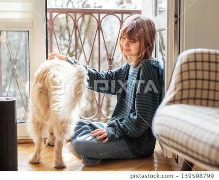 Child and dog bonding by window at home Child and dog bonding by window at home 139598799