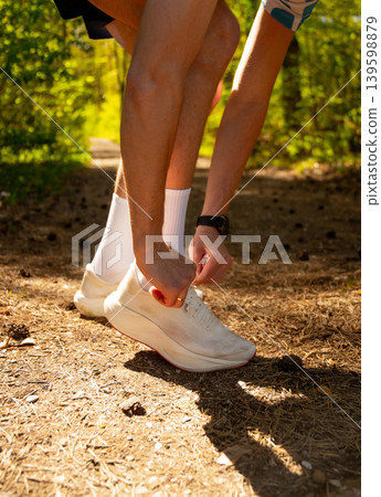 Close-up of a male runner tying a shoelace 139598879