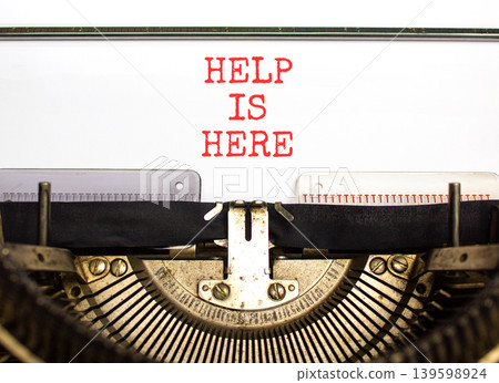 Help is here and support words symbol. Concept words Help is here typed on beautiful old retro typewriter. Beautiful white background. Business help is here and support concept. Copy space. Help is here and support words symbol. Concept words Help is here typed on beautiful old retro typewriter. Beautiful white background. Business help is here and support concept. Copy space. 139598924
