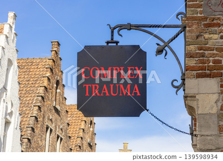 Complex trauma words symbol. Concept words Complex trauma on beautiful black road sign. Beautiful blue sky Brugge street background. Psychological complex trauma support concept. Copy space. 139598934