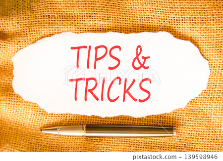 Tips and tricks words symbol. Concept words Tips and tricks on beautiful white paper. Beautiful canvas background. Business tips and tricks motivational support concept. Copy space. 139598946