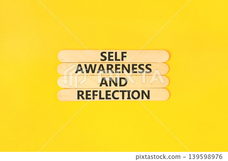 Self awareness and reflection symbol. Concept words Self awareness and reflection on beautiful wooden sticks. Beautiful yellow background. Psychological self awareness reflection concept. Copy space. Self awareness and reflection symbol. Concept words Self awareness and reflection on beautiful wooden sticks. Beautiful yellow background. Psychological self awareness reflection concept. Copy space. 139598976