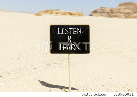 Listen and learn words symbol. Concept words Listen and learn on beautiful blackboard. Beautiful Sinai desert sand background. Business listen and learn support concept. Copy space. Listen and learn words symbol. Concept words Listen and learn on beautiful blackboard. Beautiful Sinai desert sand background. Business listen and learn support concept. Copy space. 139599031