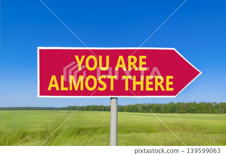 You are almost there symbol. Concept words You are almost there on beautiful red road sign. Beautiful blue sky background. Business You are almost there motivational support concept. Copy space You are almost there symbol. Concept words You are almost there on beautiful red road sign. Beautiful blue sky background. Business You are almost there motivational support concept. Copy space 139599063