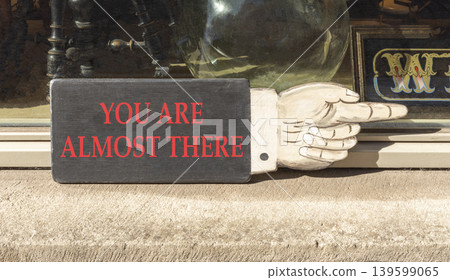 You are almost there words symbol. Concept words You are almost there on beautiful wooden sign. Beautiful shopfront background. Business You are almost there motivational support concept. Copy space You are almost there words symbol. Concept words You are almost there on beautiful wooden sign. Beautiful shopfront background. Business You are almost there motivational support concept. Copy space 139599065