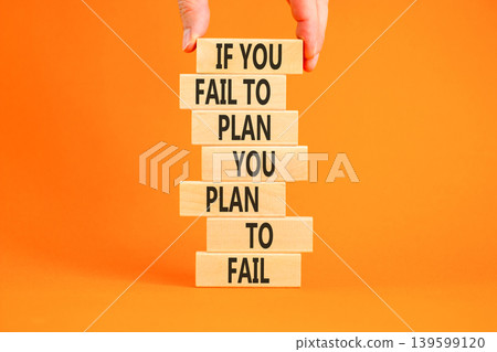 Planning to fail symbol. Concept words If you fail to plan you plan to fail on beautiful wooden blocks. Beautiful orange background. Businessman hand. Business planning to fail concept. Copy space. Planning to fail symbol. Concept words If you fail to plan you plan to fail on beautiful wooden blocks. Beautiful orange background. Businessman hand. Business planning to fail concept. Copy space. 139599120