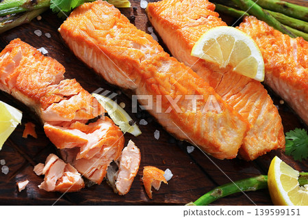 fried salmon with asparagus and lemon on a board 139599151