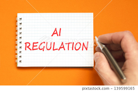 AI regulation symbol. Concept words AI artificial intelligence regulation on beautiful white note. Beautiful orange background. Business AI artificial intelligence regulation concept. Copy space. 139599165