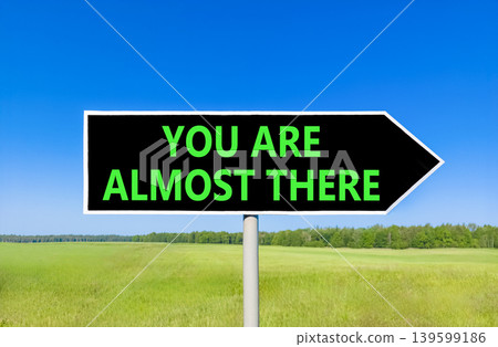 You are almost there symbol. Concept words You are almost there on beautiful black road sign. Beautiful blue sky background. Business You are almost there motivational support concept. Copy space You are almost there symbol. Concept words You are almost there on beautiful black road sign. Beautiful blue sky background. Business You are almost there motivational support concept. Copy space 139599186