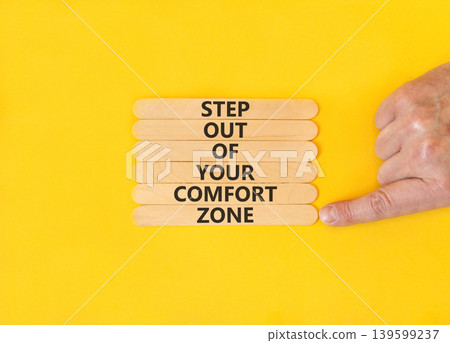 Leave comfort zone symbol. Concept words Step out of your comfort zone on beautiful wooden stick. Beautiful yellow background. Business psychological step out your comfort zone concept. Copy space. Leave comfort zone symbol. Concept words Step out of your comfort zone on beautiful wooden stick. Beautiful yellow background. Business psychological step out your comfort zone concept. Copy space. 139599237