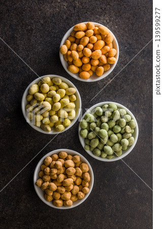 Assorted Coated Peanuts In Small Bowls Over Dark Background. Colorful Crunchy Snack Assortment Assorted Coated Peanuts In Small Bowls Over Dark Background. Colorful Crunchy Snack Assortment 139599277