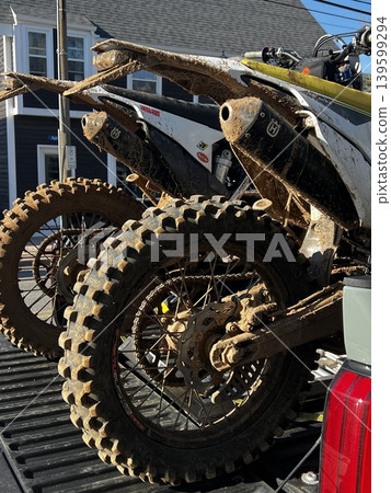 Off-road motorcycle with tires covered in dirt Off-road motorcycle with tires covered in dirt 139599294