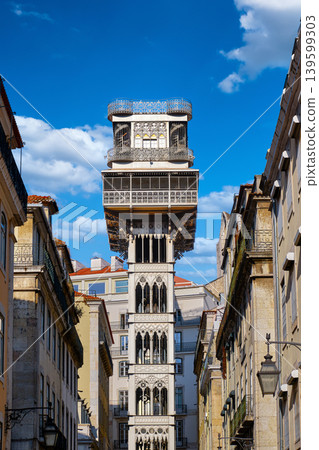 Famous Santa Justa elevator or lift in historic center, Lisbon, Portugal between Baixa and Bairro Alto on sunny day under blue sky with clouds. Iron tower, iconic city landmark, travel destination 139599303