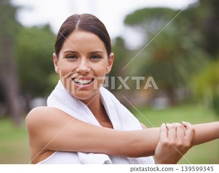 Park, portrait or happy woman stretching arms in running training, exercise or outdoor workout. Nature, smile or healthy girl runner with towel, ready to start activity for fitness, sports or warm up Park, portrait or happy woman stretching arms in running training, exercise or outdoor workout. Nature, smile or healthy girl runner with towel, ready to start activity for fitness, sports or warm up 139599345