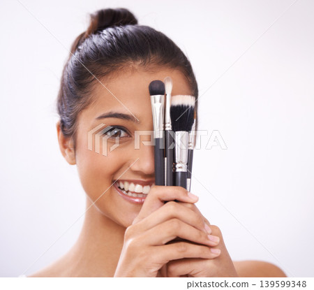 Makeup, brushes and woman face with eyes cosmetics in studio for beauty and foundation on a white background. Young model, artist or person in portrait for skincare, eyeshadow or product for coverage Makeup, brushes and woman face with eyes cosmetics in studio for beauty and foundation on a white background. Young model, artist or person in portrait for skincare, eyeshadow or product for coverage 139599348