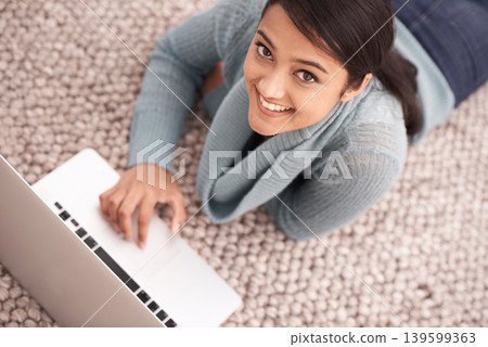 Portrait of happy woman on carpet with laptop, relax and smile with studying, research or browse on web from above. Face of student girl on floor with computer, elearning and online education in home Portrait of happy woman on carpet with laptop, relax and smile with studying, research or browse on web from above. Face of student girl on floor with computer, elearning and online education in home 139599363