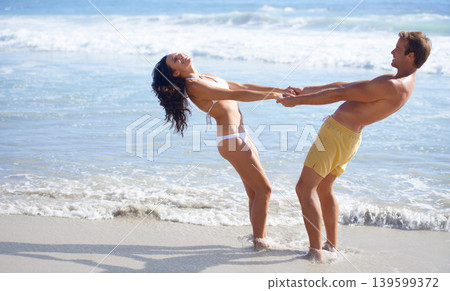 Love, smile and playful couple on beach together for energy, vacation or honeymoon fun in summer. Travel, laughing or funny with young man and woman in water, sea or ocean for holiday bonding Love, smile and playful couple on beach together for energy, vacation or honeymoon fun in summer. Travel, laughing or funny with young man and woman in water, sea or ocean for holiday bonding 139599372