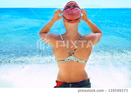 Swimmer, back and woman at ocean outdoor in summer for exercise, water training or workout. Sea, sport athlete cap and rear view of person in nature for fitness, health or triathlon at the beach Swimmer, back and woman at ocean outdoor in summer for exercise, water training or workout. Sea, sport athlete cap and rear view of person in nature for fitness, health or triathlon at the beach 139599373
