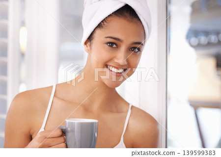 Woman, coffee and portrait in a home with a towel in the morning from hot drink and cup. Lounge, happy and relax Indian female person with espresso or tea in a house ready to start the day with a mug Woman, coffee and portrait in a home with a towel in the morning from hot drink and cup. Lounge, happy and relax Indian female person with espresso or tea in a house ready to start the day with a mug 139599383