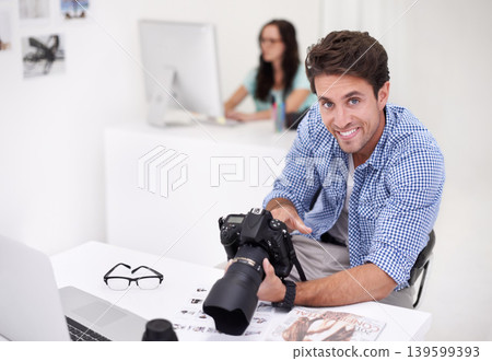 Camera, portrait and photographer looking at photoshoot in a studio or workshop for production. Creative, smile and artist with dslr equipment for photography picture inspection in modern workplace. Camera, portrait and photographer looking at photoshoot in a studio or workshop for production. Creative, smile and artist with dslr equipment for photography picture inspection in modern workplace. 139599393