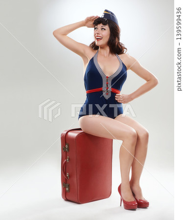 Travel, flight attendant and happy woman salute for fashion on a suitcase in studio isolated on a white background mockup space. Luggage, air hostess and smile of retro stewardess on bag for journey Travel, flight attendant and happy woman salute for fashion on a suitcase in studio isolated on a white background mockup space. Luggage, air hostess and smile of retro stewardess on bag for journey 139599436