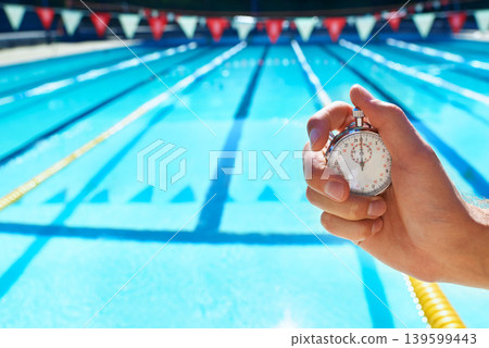 Hand, timer and swimming pool for sport, training and workout with preparation for competition. Person, coach or mentor with clock, stopwatch or check for speed, progress and tracking lap for race 139599443