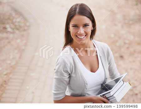 Woman, portrait and books with tablet by road outside, technology and education for learning at university. Park, student and face by happy connection, college and commitment with networking online 139599498