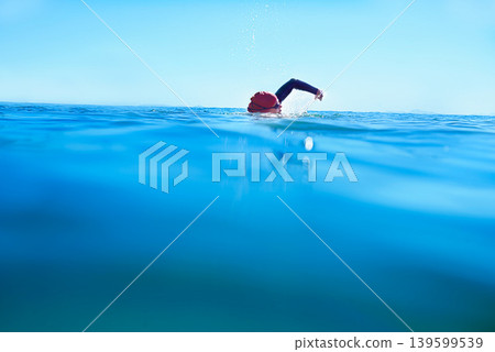 Swimming, stroke and person in sea water in summer for exercise, training or workout on mockup space. Ocean, sport and a athlete crawl outdoor for fitness, health and triathlon competition in nature Swimming, stroke and person in sea water in summer for exercise, training or workout on mockup space. Ocean, sport and a athlete crawl outdoor for fitness, health and triathlon competition in nature 139599539
