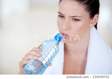 Tired, relax or woman drinking water on break after exercise, workout or fitness training in gym. Fatigue, healthy person or thirsty sports athlete with liquid bottle for wellness, rest or hydration Tired, relax or woman drinking water on break after exercise, workout or fitness training in gym. Fatigue, healthy person or thirsty sports athlete with liquid bottle for wellness, rest or hydration 139599702
