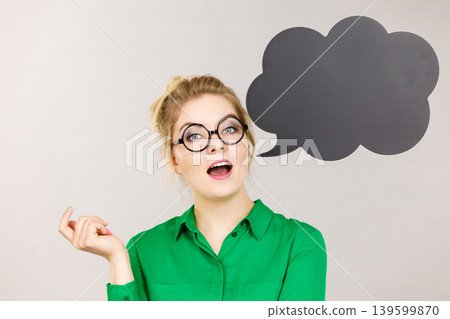 Woman holding black thinking bubble 139599870