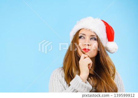 Funny woman in Christmas Santa hat Funny woman in Christmas Santa hat 139599912