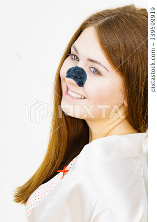 Woman with nose mask pore strips 139599919