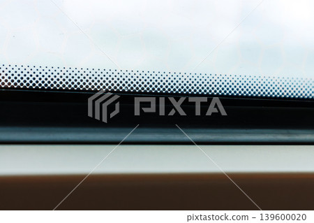 Train window with shallow depth of field, with raindrops on the glass and a foggy view outside and subtle motion blur. Minimal travel detail with atmospheric mood. Copy space Train window with shallow depth of field, with raindrops on the glass and a foggy view outside and subtle motion blur. Minimal travel detail with atmospheric mood. Copy space 139600020