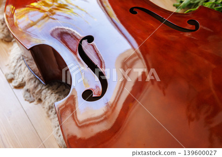 Closeup of a stringless double bass body under repair or in preparation 139600027