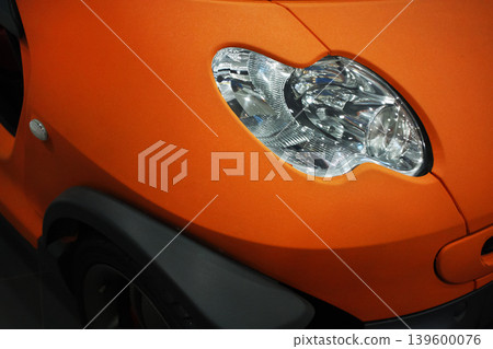 Orange car, headlight close-up. Car paint advertisement 139600076