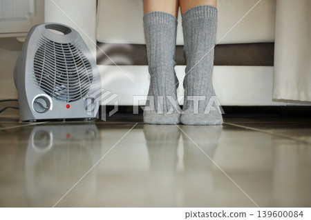 Electric heater on carpet in living room. Home heating.Warm air. Electric heater on carpet in living room. Home heating.Warm air. 139600084