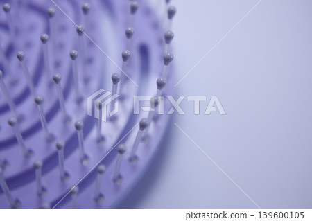 Comb close up, purple background for beauty salons or hair treatment centers 139600105