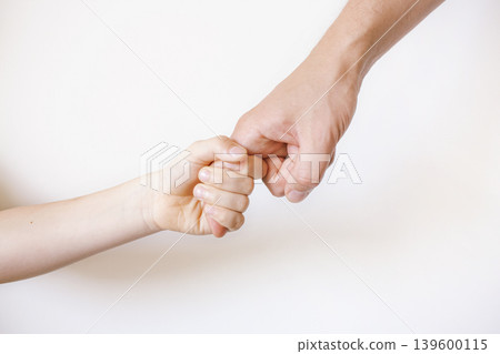 Child holds dad's finger. White background Child holds dad's finger. White background 139600115