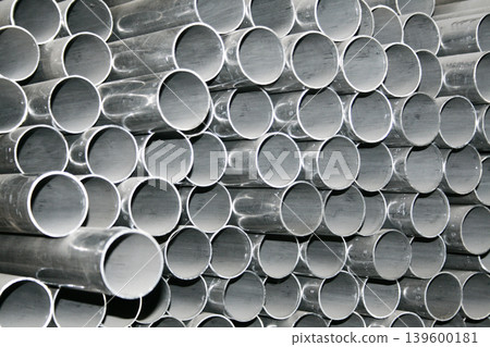 Metal steel pipe for construction materials, aluminium or stainless steel products on a factory or warehouse. Metal steel pipe for construction materials, aluminium or stainless steel products on a factory or warehouse. 139600181