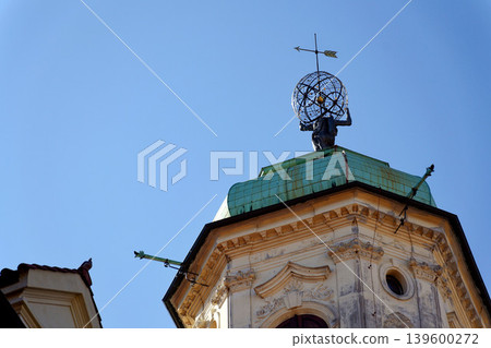 Astronomical Tower of the Klementinum in Prague with Atlant statue holding heavens, Czech Republic, clear blue sky, sunny day 139600272