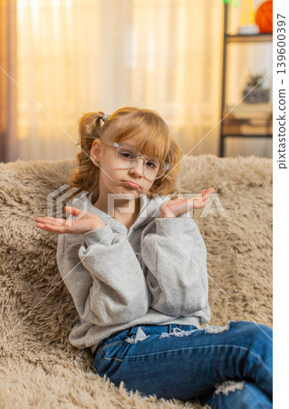 Confused teenager girl feeling embarrassed about ambiguous question, having doubts, no idea Confused teenager girl feeling embarrassed about ambiguous question, having doubts, no idea 139600397