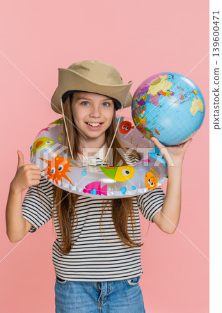 Child girl kid with inflatable ring looking at world map planning holiday trip with excitement 139600471