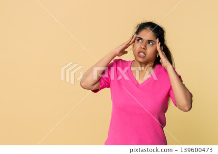 Indian woman touching temples, visibly distressed experiencing headache and fatigue 139600473