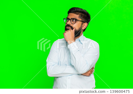 Indian young man sighing with tired expression showing light dissatisfaction daily routine boredom Indian young man sighing with tired expression showing light dissatisfaction daily routine boredom 139600475