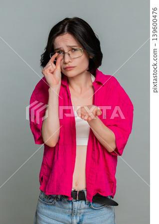 Woman holding hands together pleading with head tilted emotionally begging asking favor gesture Woman holding hands together pleading with head tilted emotionally begging asking favor gesture 139600476