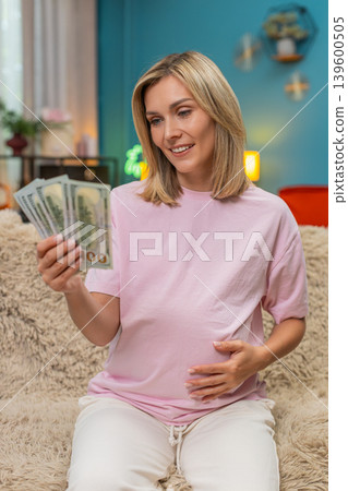 Pregnant woman counting dollars cash money planning budget for childbirth calm financial security Pregnant woman counting dollars cash money planning budget for childbirth calm financial security 139600505