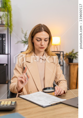 Businesswoman checks contract with magnifier fine print flags risks waves no signs confident smile Businesswoman checks contract with magnifier fine print flags risks waves no signs confident smile 139600517
