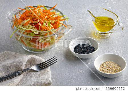 Light vegetable salad of cabbage and carrots with sesame seeds and dressed with olive oil Light vegetable salad of cabbage and carrots with sesame seeds and dressed with olive oil 139600652