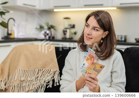 Woman counts euro money cash celebrates high salary and savings plans invest and dream purchase Woman counts euro money cash celebrates high salary and savings plans invest and dream purchase 139600666